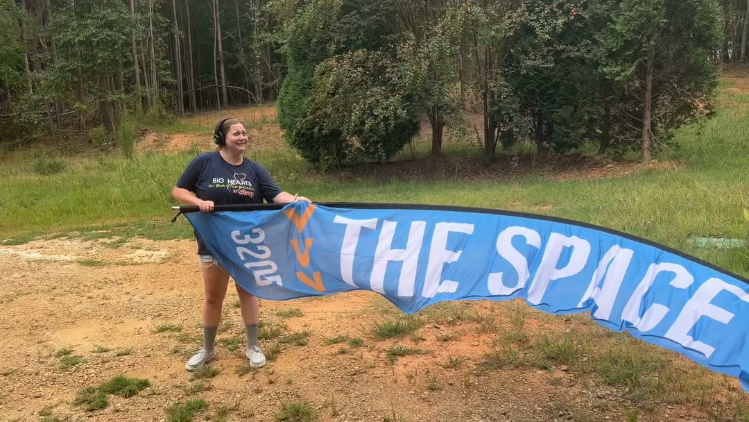 Holding The SPACE flag banner